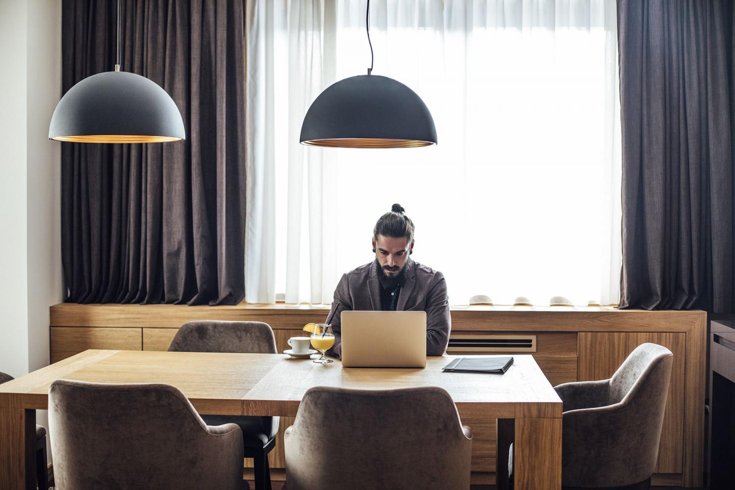Day Rooms As Workspaces—The Future of Remote Work? - Man works hotel