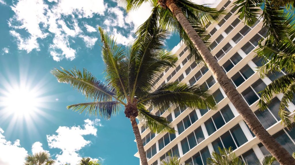 miami beach hotel: upward camera angle of highrise hotel in miami beach