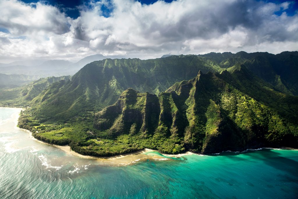 aerial view of napali coast in kauai hawaii lush green mountains and blue ocean