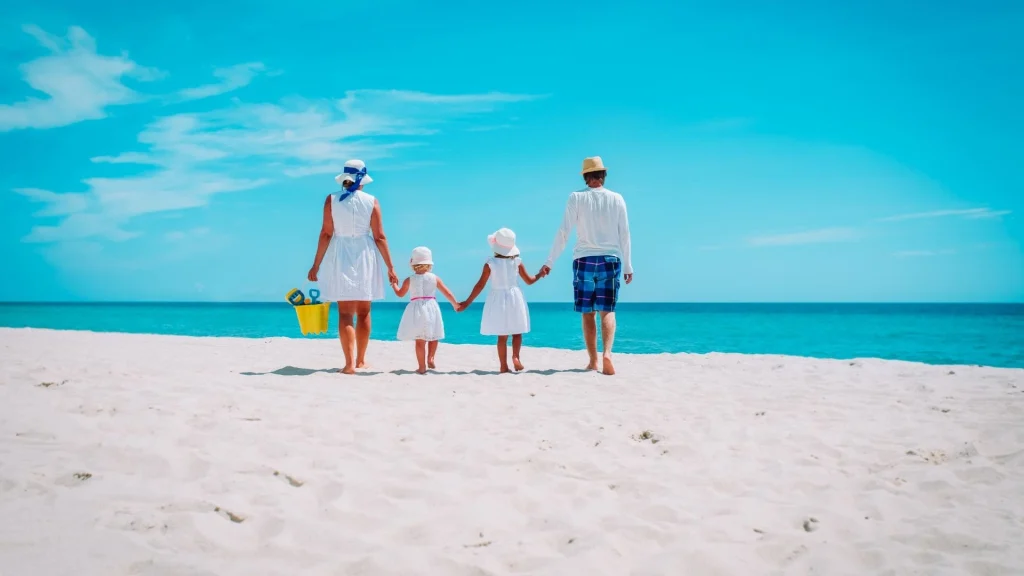 hotels by day family walking on the beach for a daycation, staycation, or vacation