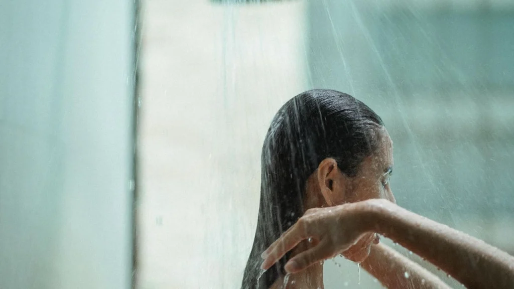 where to shower at lax airport: woman enjoying a shower