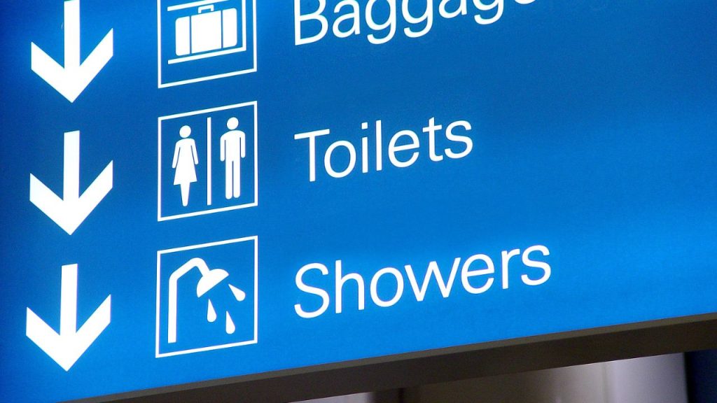 airport sign hanging from ceiling showing shower facilities