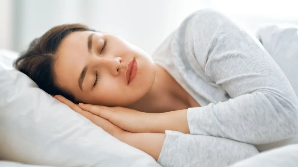 woman sleeping in a day use hotel bed during layover