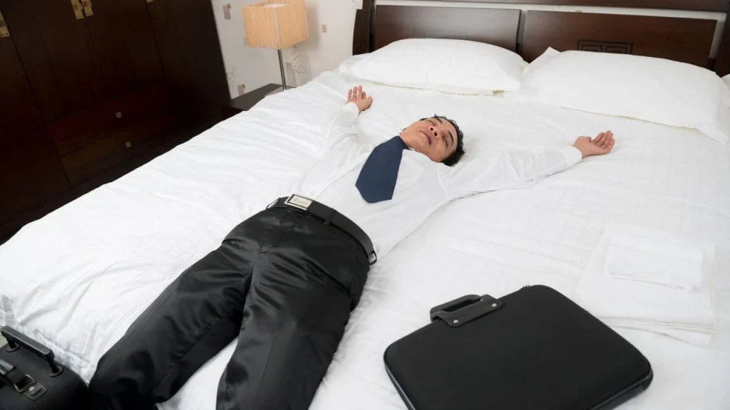 layover-day-use-hotel: man in business casual wear spread out on the bread