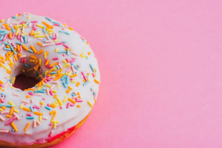 nashville bakery: up close of a doughnut on a pink background