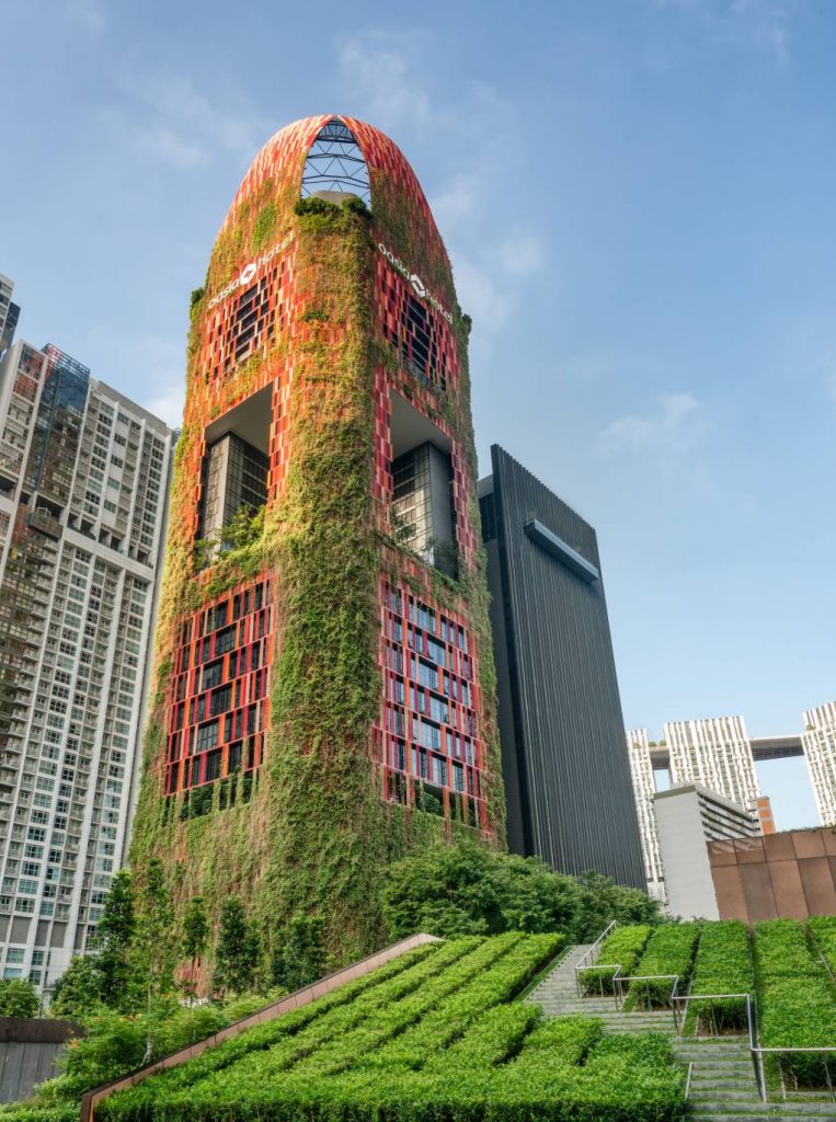 Vegetation lines the prominent Oasia Hotel Downtown in Singapore.